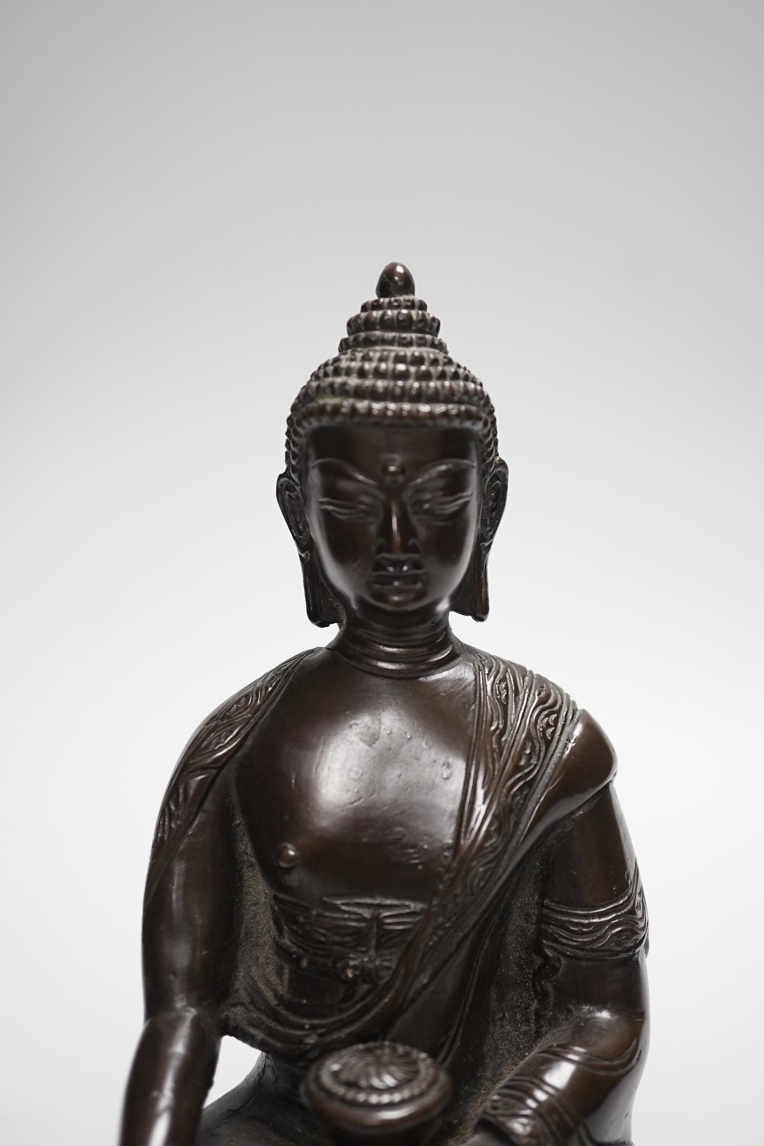 A Chinese bronze Buddha, on lotus base, 20cms high